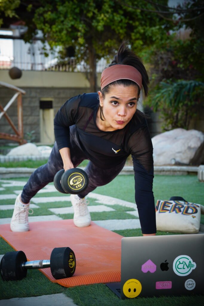 woman working out with weights on a Yoga mat